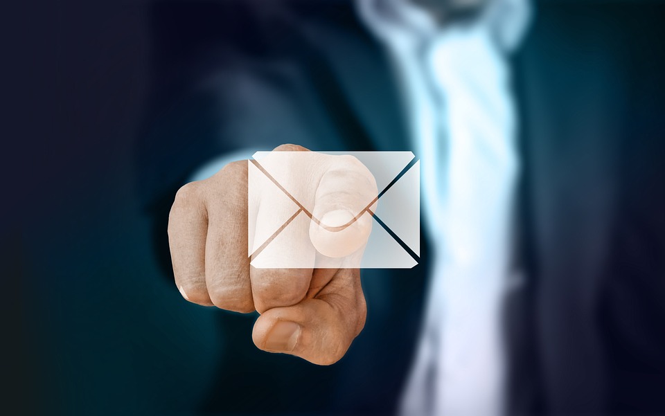 picture of a man in a suit touching a digital envelope with his index finger
